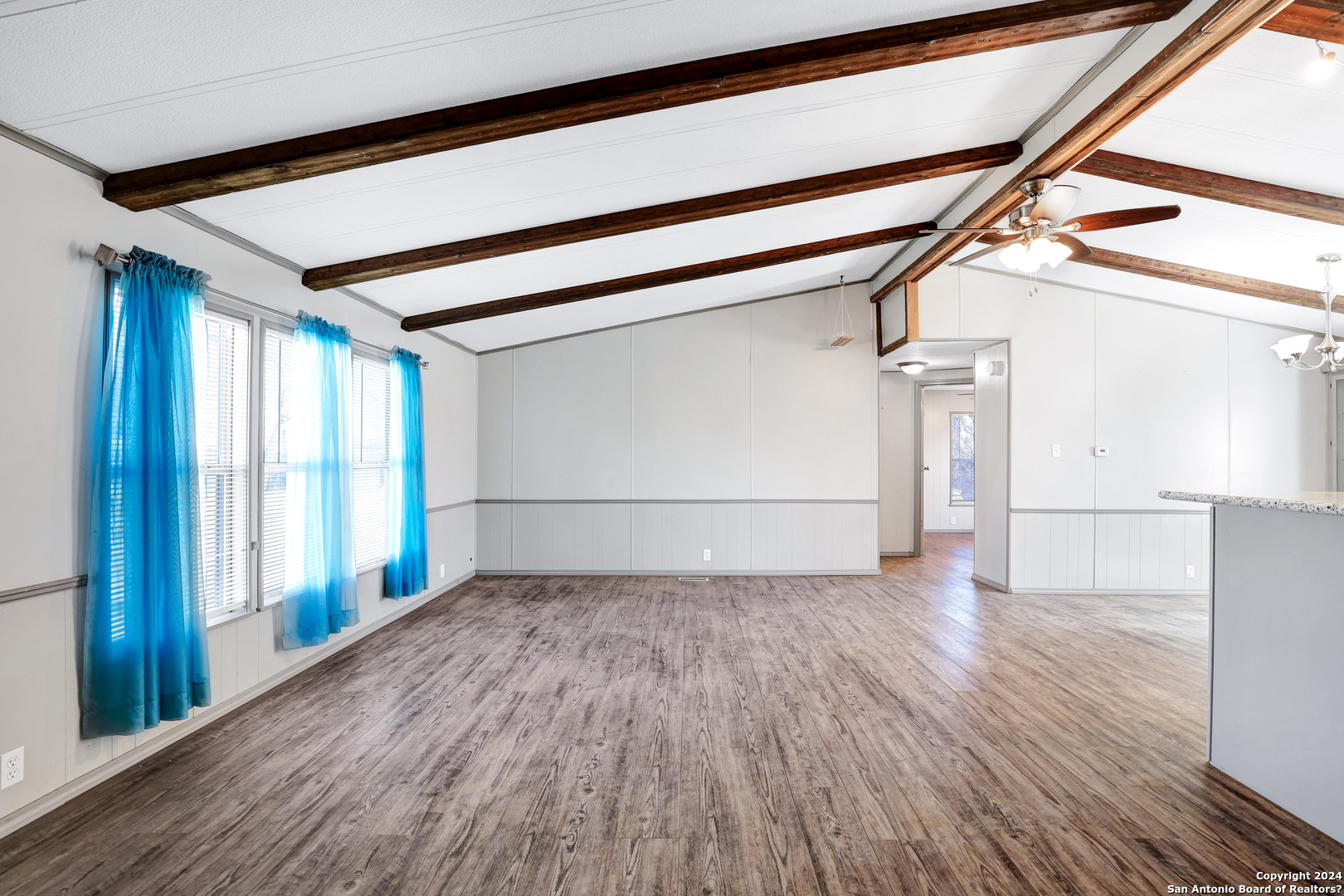 18066 La Gloria Road Elmendorf, TX 78112 - Photo 3 of 24 a view of a room with wooden floor and stairs