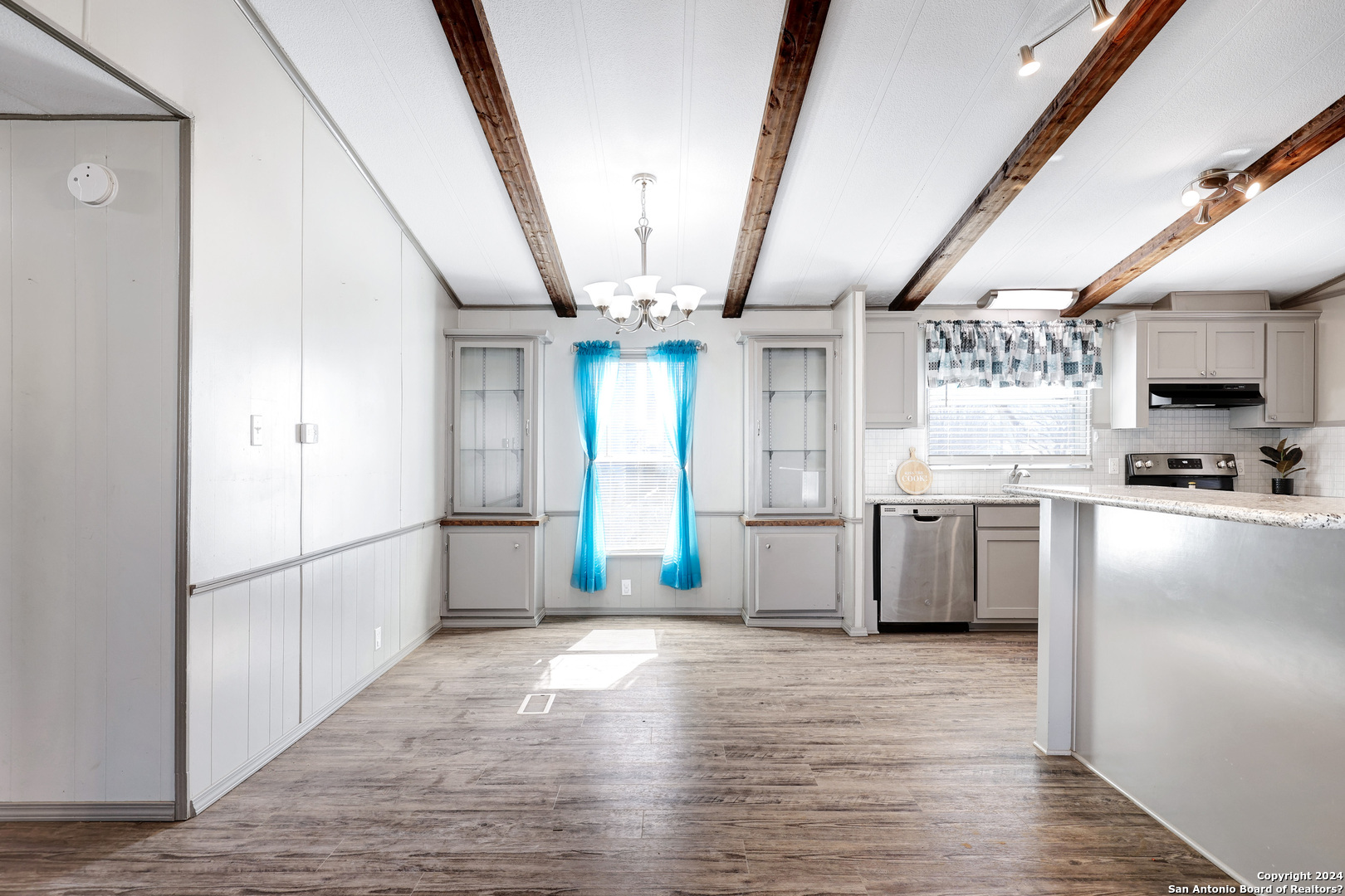 18066 La Gloria Road Elmendorf, TX 78112 - Photo 8 of 24 a kitchen with stainless steel appliances granite countertop a refrigerator and a sink