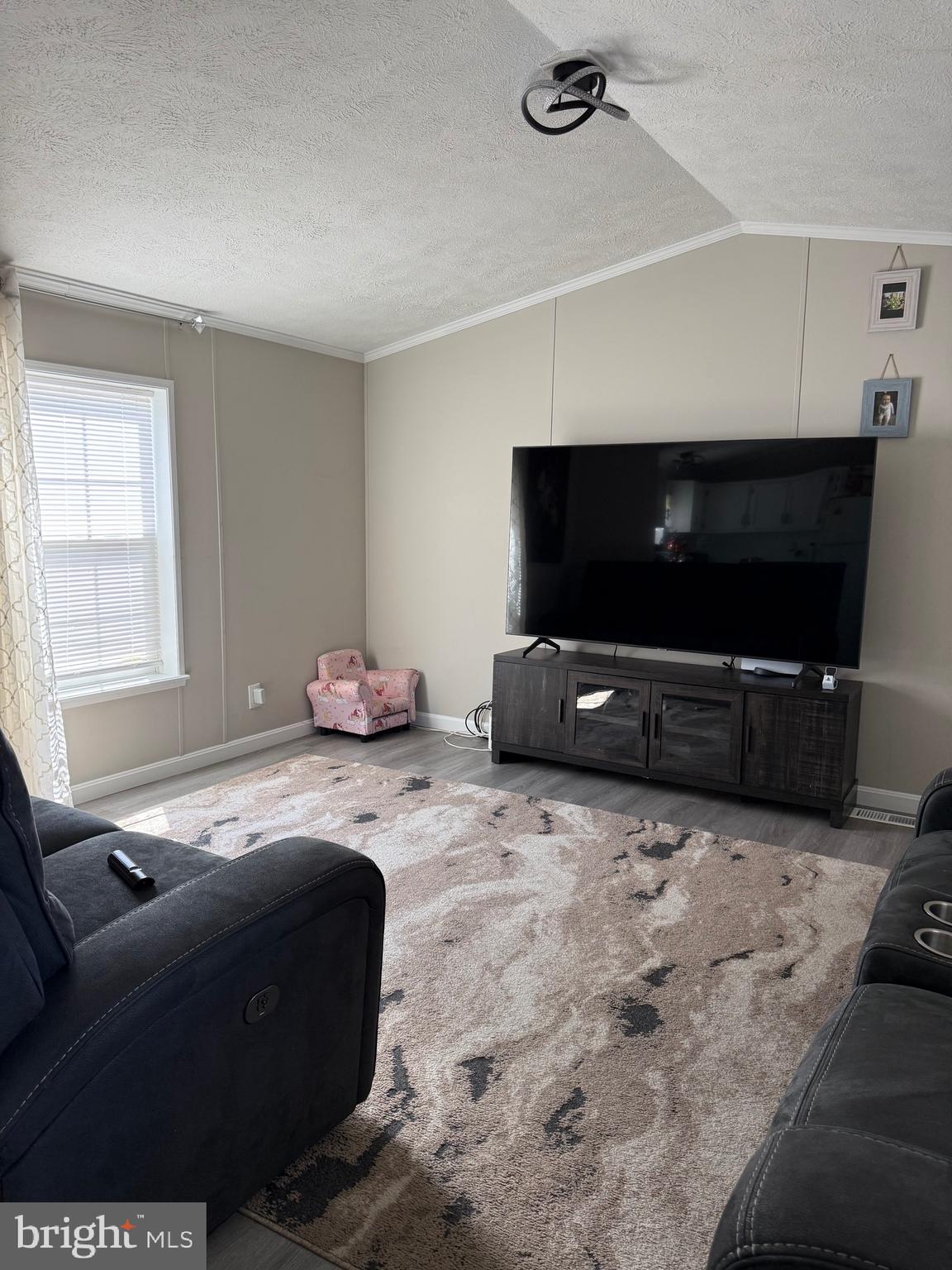 7959 Telegraph Road Severn, MD 21144 - Photo 3 of 18 a living room with furniture and a flat screen tv