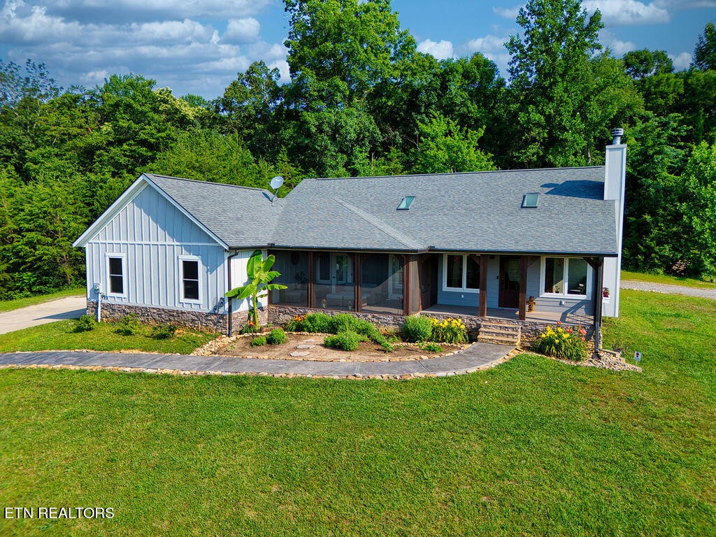 9760 Chestnut Ridge Road Heiskell, TN 37754 - Photo 1 of 59 a view of a house with backyard sitting area and garden