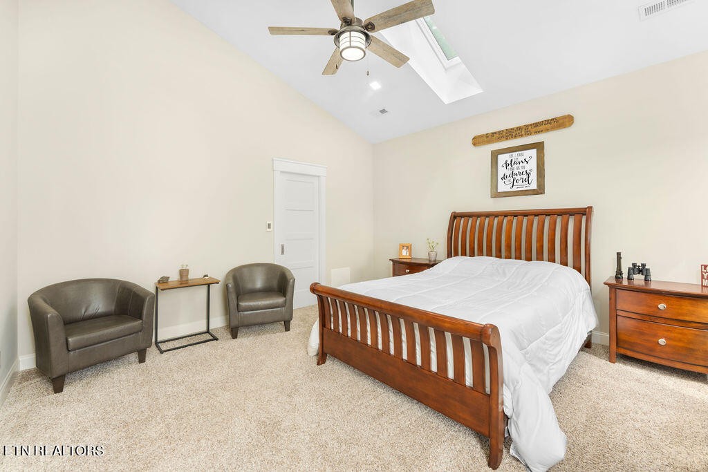 9760 Chestnut Ridge Road Heiskell, TN 37754 - Photo 17 of 59 a bedroom with a bed and cabinets