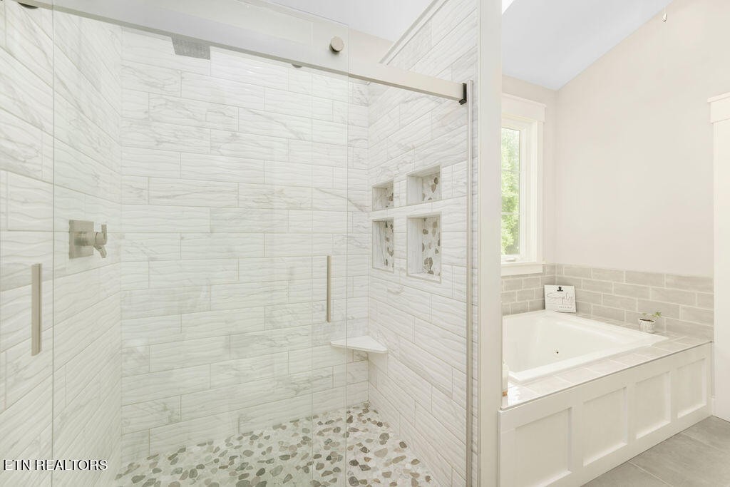 9760 Chestnut Ridge Road Heiskell, TN 37754 - Photo 20 of 59 a bathroom with a bathtub and shower