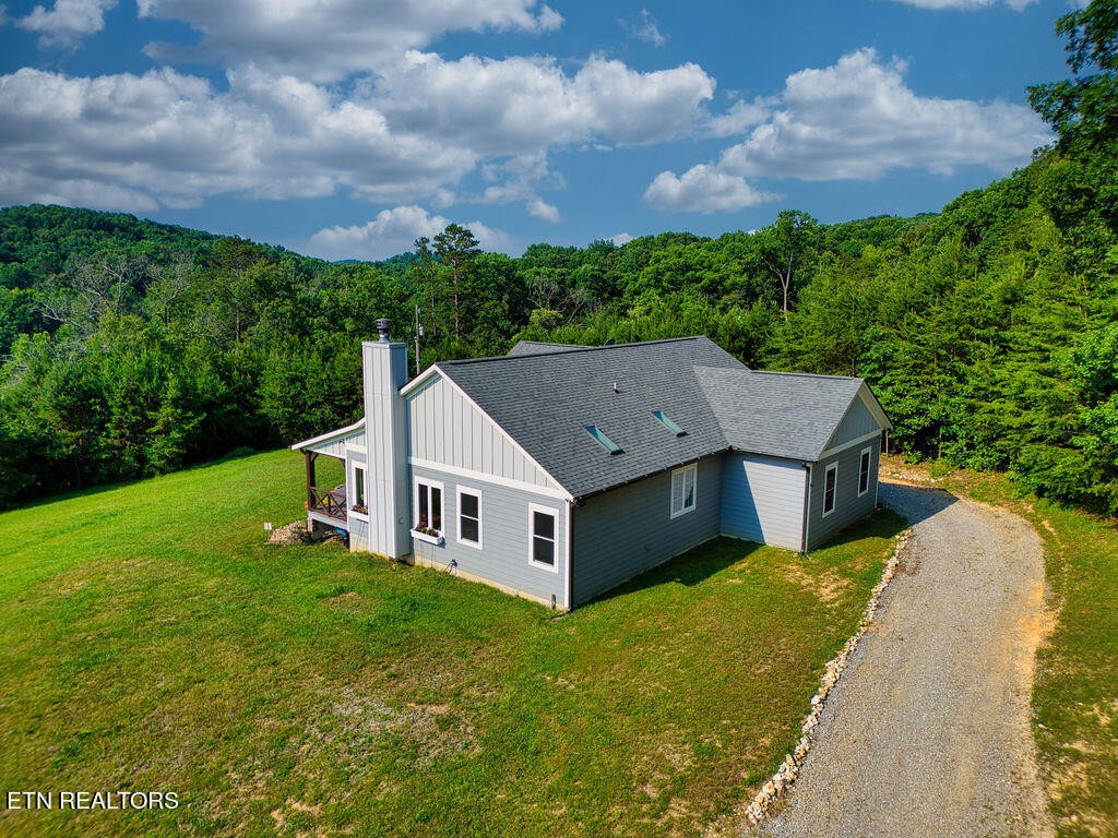 9760 Chestnut Ridge Road Heiskell, TN 37754 - Photo 45 of 59 a aerial view of a house next to a big yard and large trees