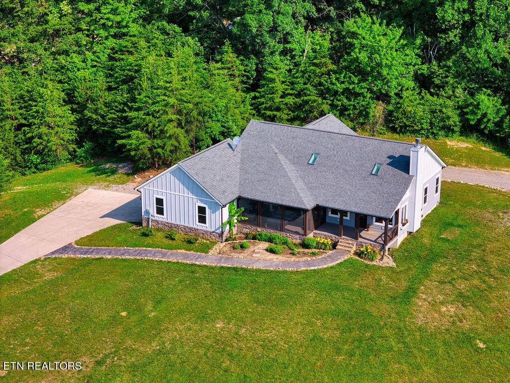 9760 Chestnut Ridge Road Heiskell, TN 37754 - Photo 48 of 59 a aerial view of a house with a yard table and chairs