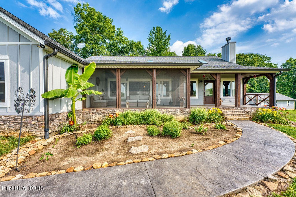 9760 Chestnut Ridge Road Heiskell, TN 37754 - Photo 58 of 59 a front view of a house with garden