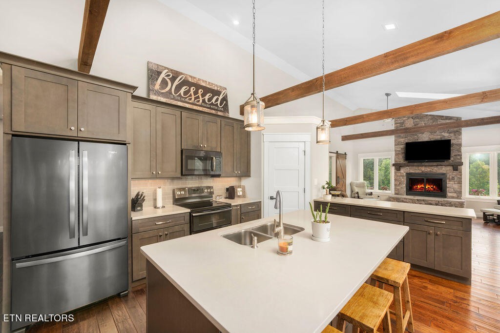 9760 Chestnut Ridge Road Heiskell, TN 37754 - Photo 7 of 59 a kitchen with stainless steel appliances granite countertop a sink a stove and a refrigerator