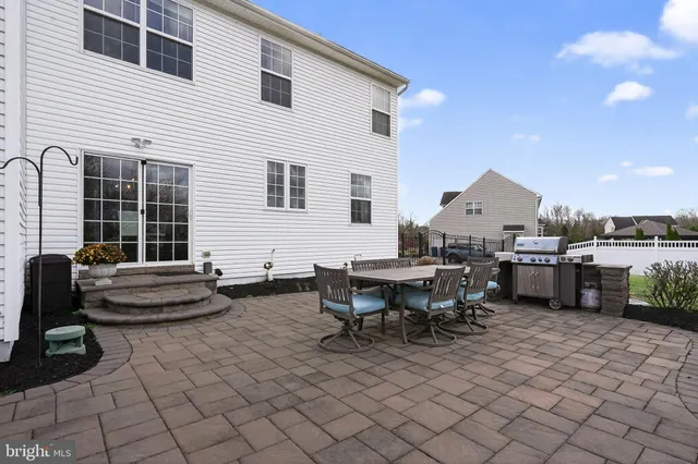 a view of a hallway with furniture and a window