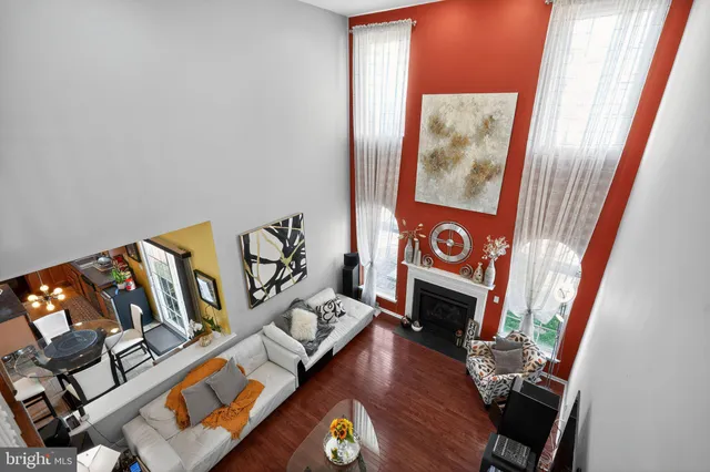 a living room with fireplace furniture and a floor to ceiling window