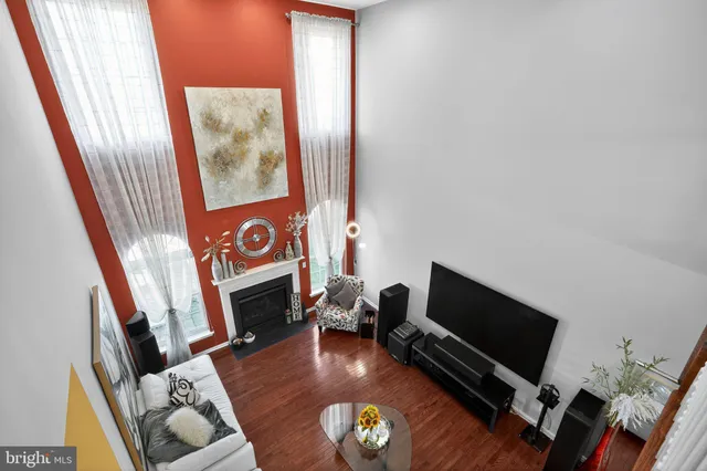 a living room with furniture a flat screen tv and a window