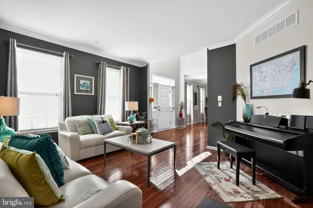 a kitchen with stainless steel appliances granite countertop a stove top oven a sink dishwasher a refrigerator and a dining table with wooden cabinet