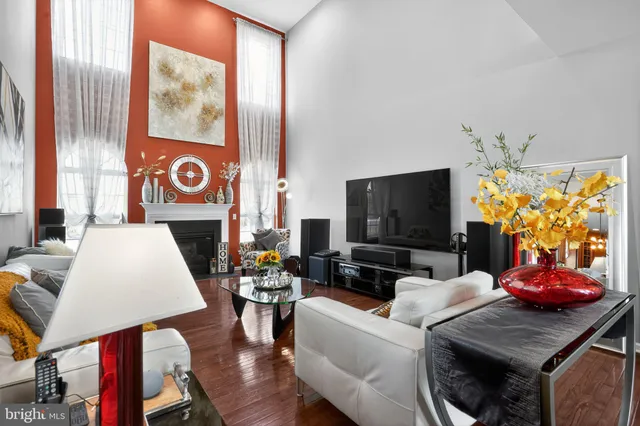 a kitchen with stainless steel appliances granite countertop a refrigerator a stove and a dining table with wooden floor