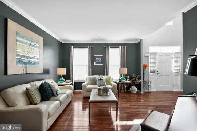 a view of a dining room with furniture wooden floor and chandelier