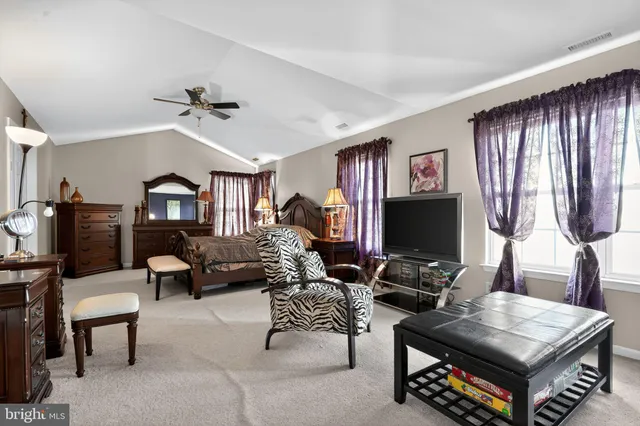 a bedroom with a bed window and book shelf