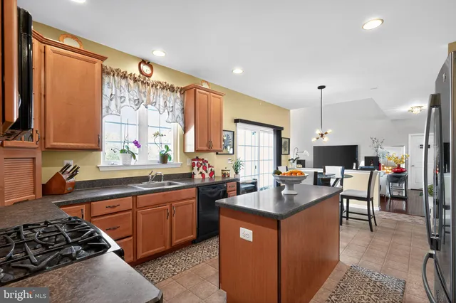 a view of a livingroom with furniture hardwood floor and a flat screen tv