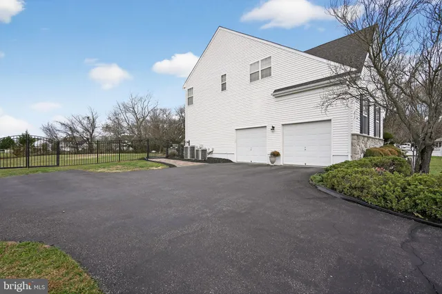 an aerial view of a house with a garden and lake view