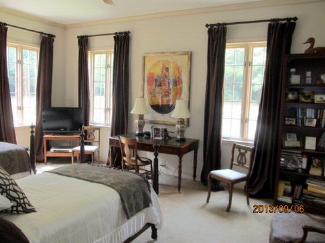 5150 Zebulon Road Macon, GA 31210 - Photo 19 of 33 a bedroom with a bed a large window and book shelf