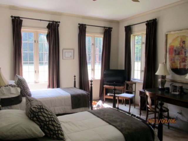5150 Zebulon Road Macon, GA 31210 - Photo 20 of 33 a bedroom with two beds and a large mirror next to a window