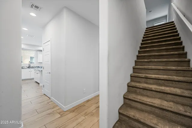 a view of entryway and hall with wooden floor