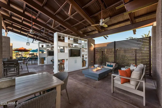 a view of yard with swimming pool and table and chairs under an umbrella