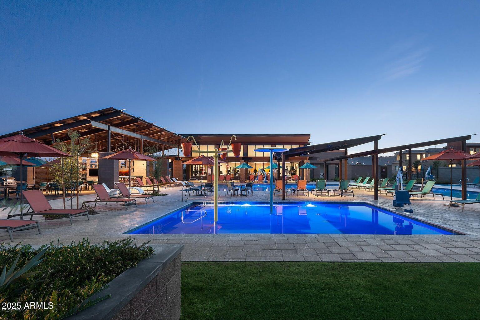 1250 Abbey Lane, Unit 289 Chandler, AZ 85226 - Photo 33 of 36 a view of yard with swimming pool and table and chairs under an umbrella