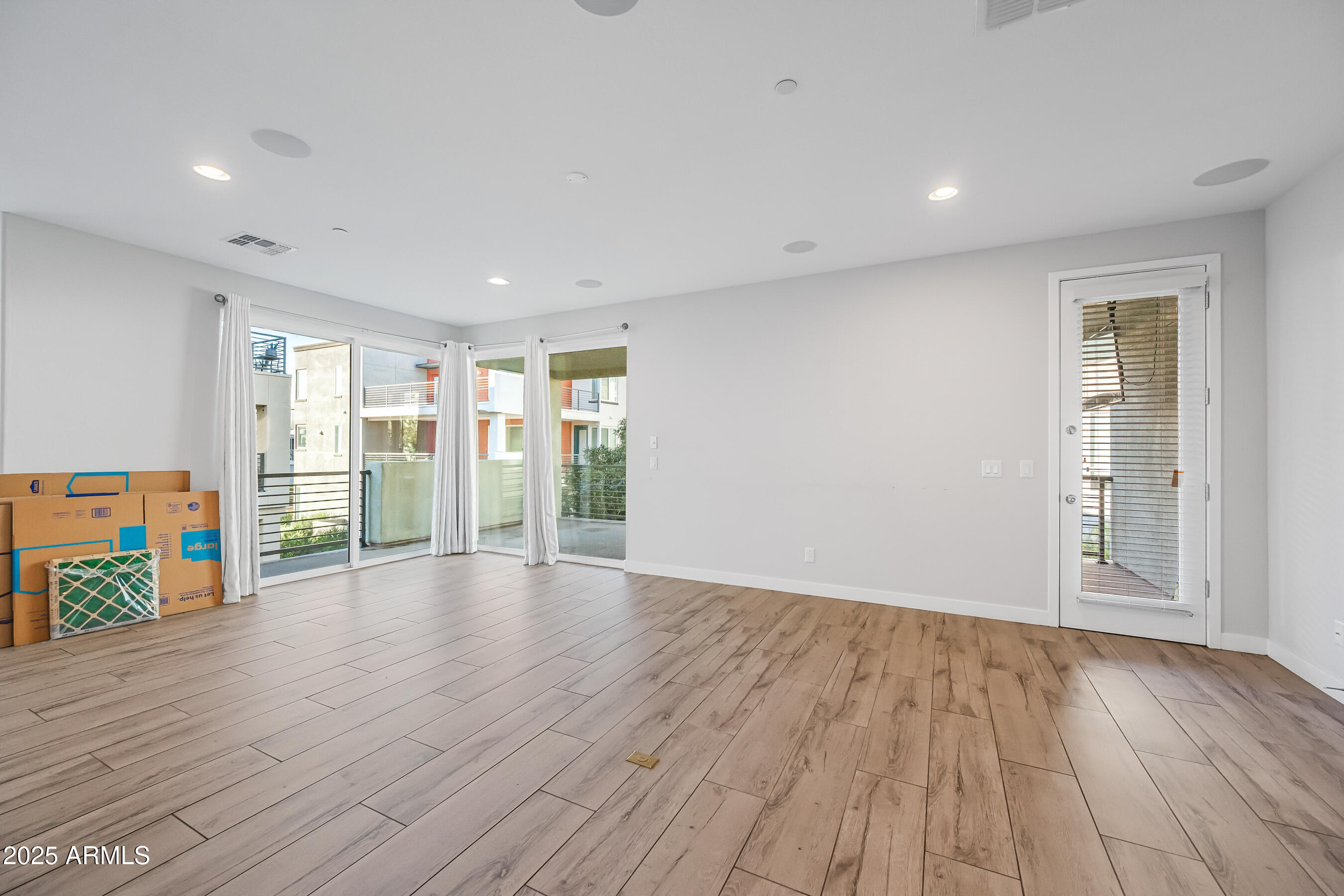 1250 Abbey Lane, Unit 289 Chandler, AZ 85226 - Photo 4 of 36 a view of an empty room with wooden floor