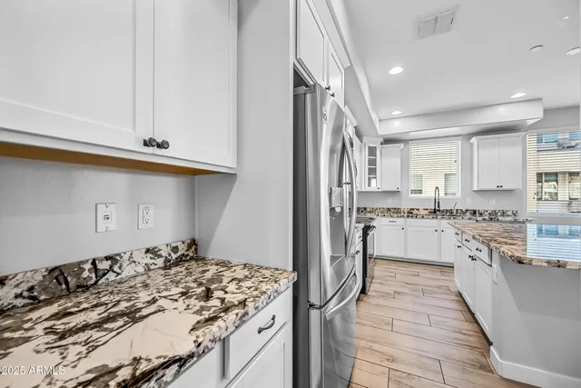 a kitchen with a sink stove and refrigerator