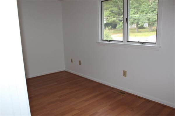1673 Petersham Road Athol, MA 01331 - Photo 5 of 5 an empty room with wooden floor and windows