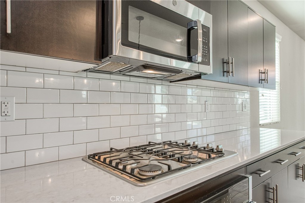 4135 Mecca Avenue Clovis, CA 93619 - Photo 13 of 32 a stove top oven sitting inside of a kitchen