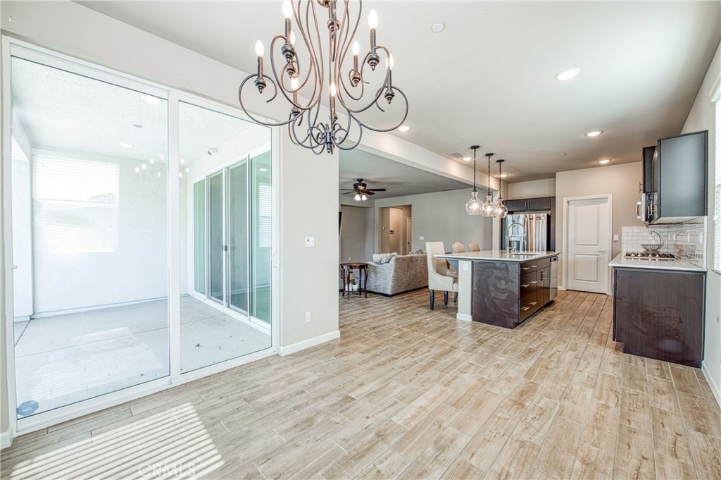 4135 Mecca Avenue Clovis, CA 93619 - Photo 15 of 32 a view of a kitchen with furniture and wooden floor