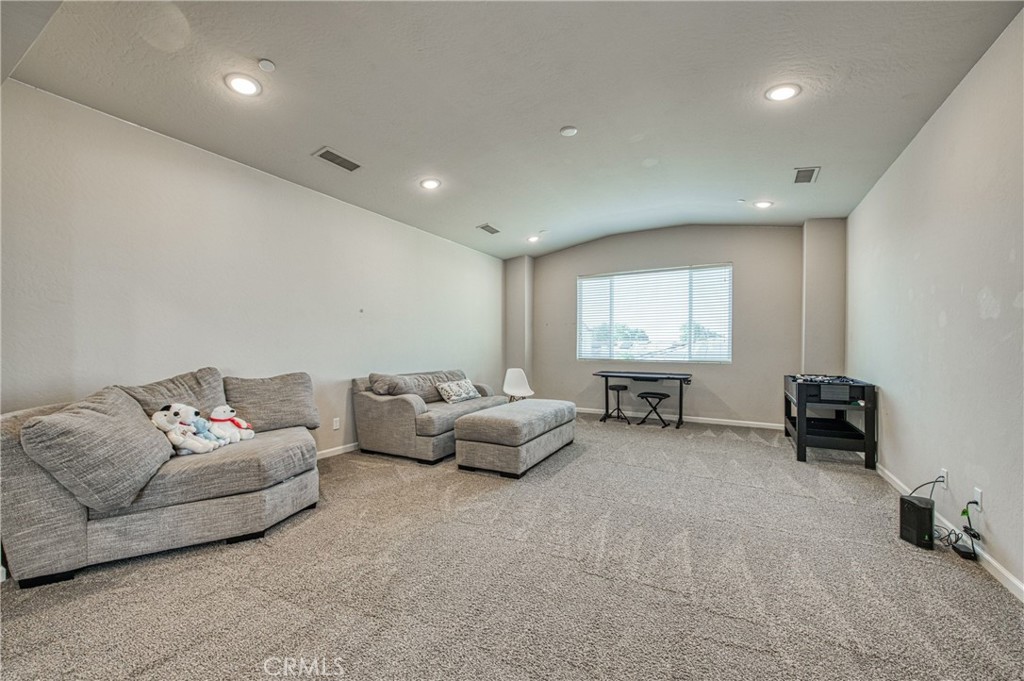 4135 Mecca Avenue Clovis, CA 93619 - Photo 23 of 32 a living room with furniture and a flat screen tv
