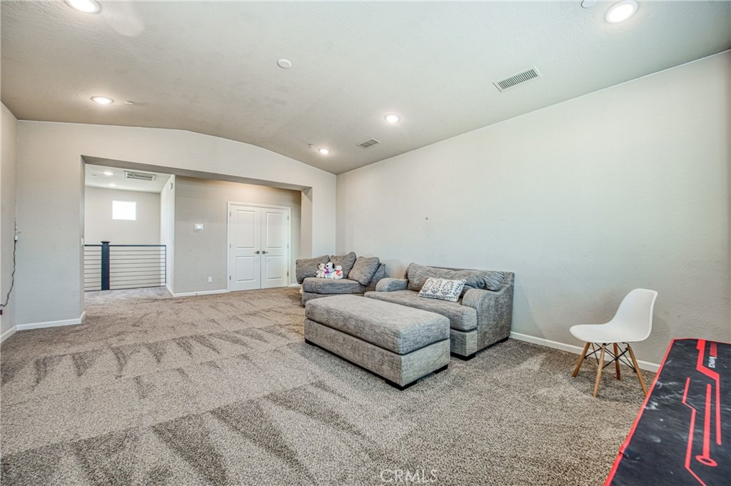 4135 Mecca Avenue Clovis, CA 93619 - Photo 24 of 32 a spacious bedroom with a bed and a chair