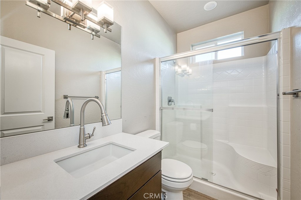 4135 Mecca Avenue Clovis, CA 93619 - Photo 6 of 32 a bathroom with a sink a toilet and shower