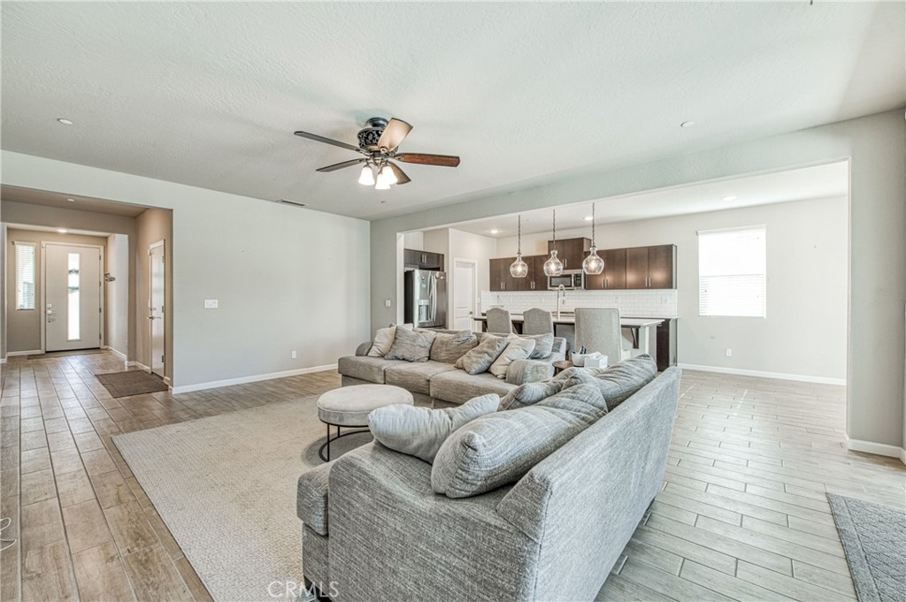 4135 Mecca Avenue Clovis, CA 93619 - Photo 9 of 32 a living room with furniture and wooden floor