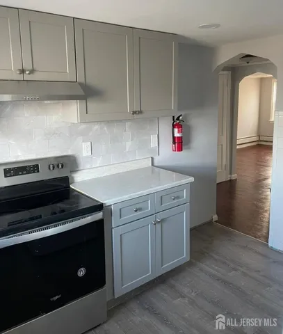 a kitchen with cabinets and steel appliances
