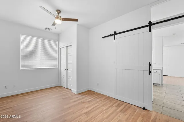 a view of empty room with wooden floor