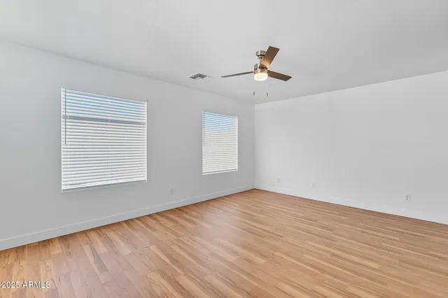 a view of a room with wooden floor