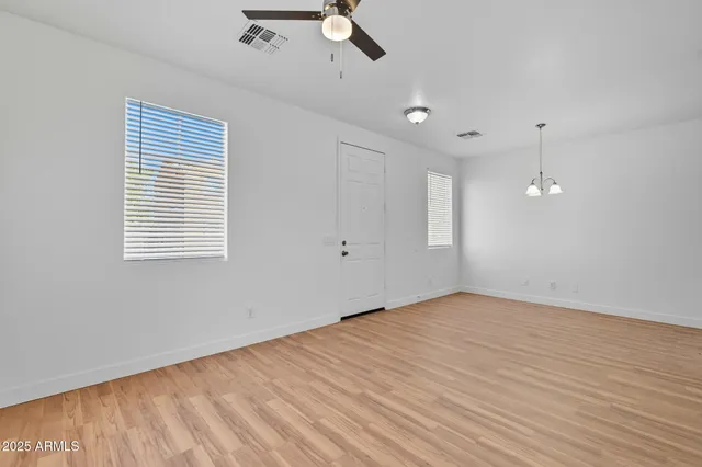 a view of an empty room with wooden floor