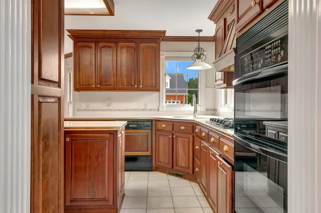 a kitchen with stainless steel appliances granite countertop a sink stove and cabinets