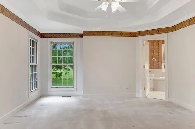 an empty room with windows and closet