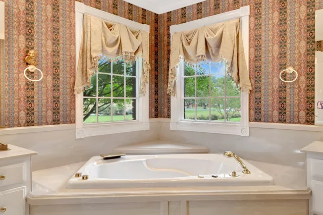 a bathroom with a bathtub and window