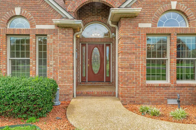 a front view of a house with large windows