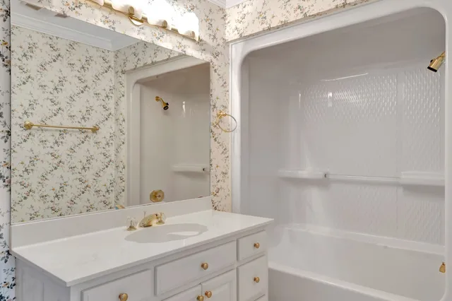 a kitchen with granite countertop white cabinets and a sink