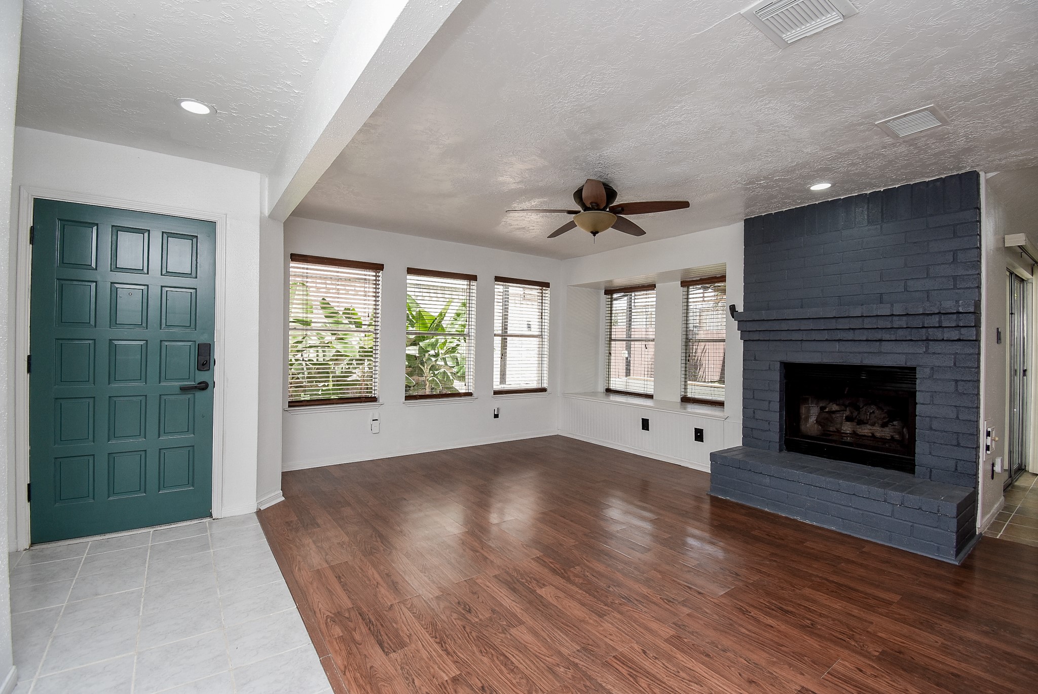 8715 Vinkins Road Houston, TX 77071 - Photo 11 of 48 Imagine relaxing in this bright and spacious living area, where the cozy fireplace, abundant natural light, and open layout create the perfect setting for entertaining family and friends.