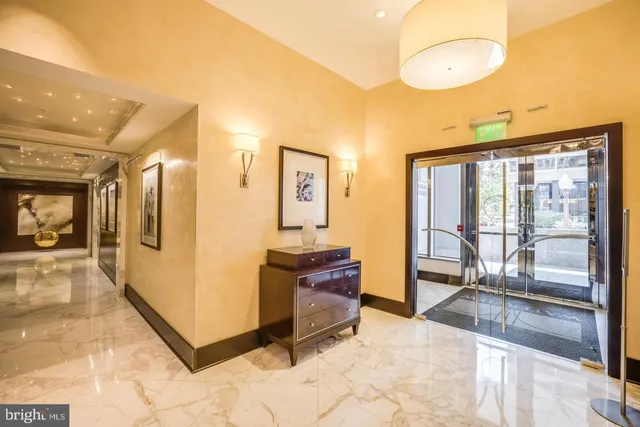 a view of a hallway with wooden floor and furniture