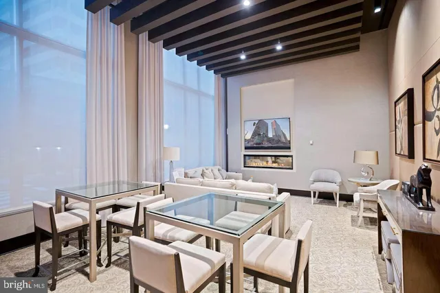 a living room with furniture a ceiling fan and a rug