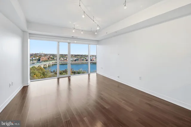 a view of a kitchen with wooden floor and outdoor space