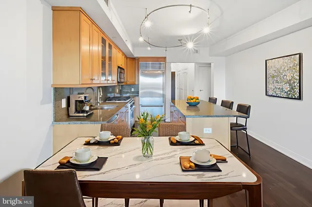 a view of a dining room with furniture a chandelier and wooden floor