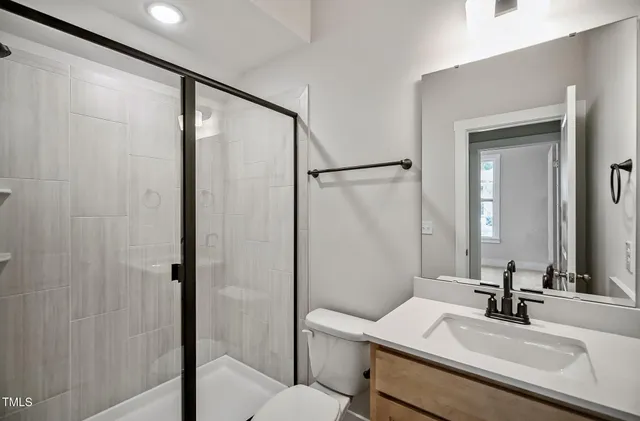 a bathroom with a sink toilet and shower