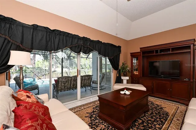 a living room with furniture chandelier and a large window