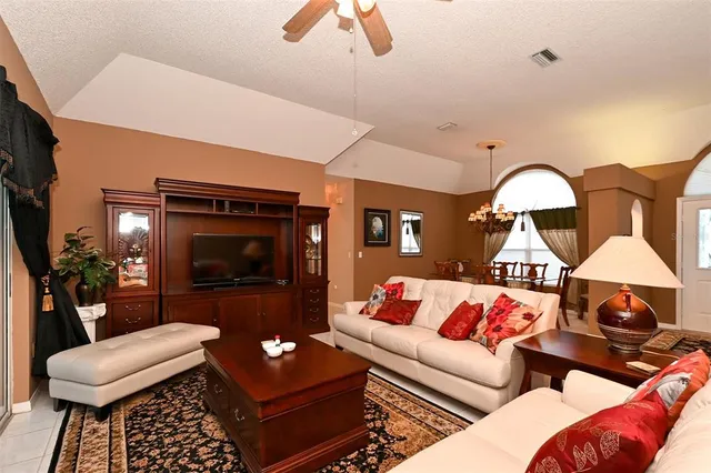 a living room with chairs and a dining table